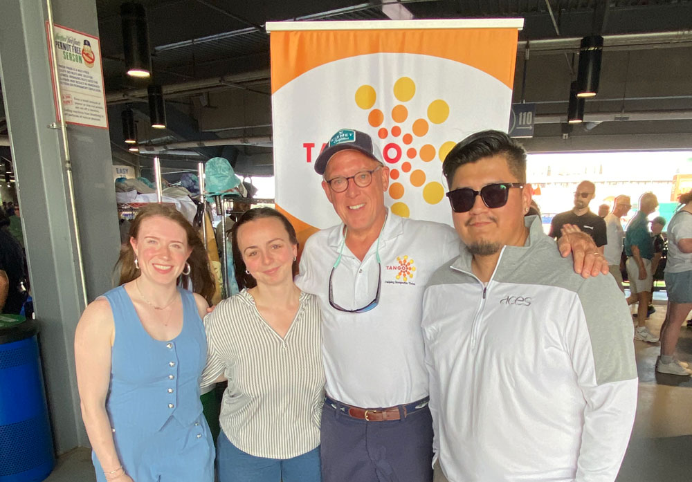 TANGO founder Rollin Schuster with three of our Rising Star Nonprofit Scholarship winners on the field at the Hartford Yard Goats.