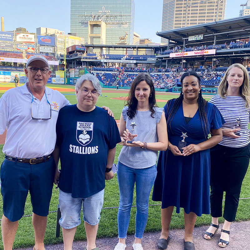 TANGO Rising Star Nonprofit Scholarship winners being announced on the field by Rollin Schuster at a Hartford Yard Goats game.